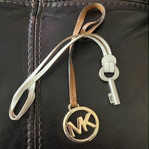 Two bag tags MK and Fossil